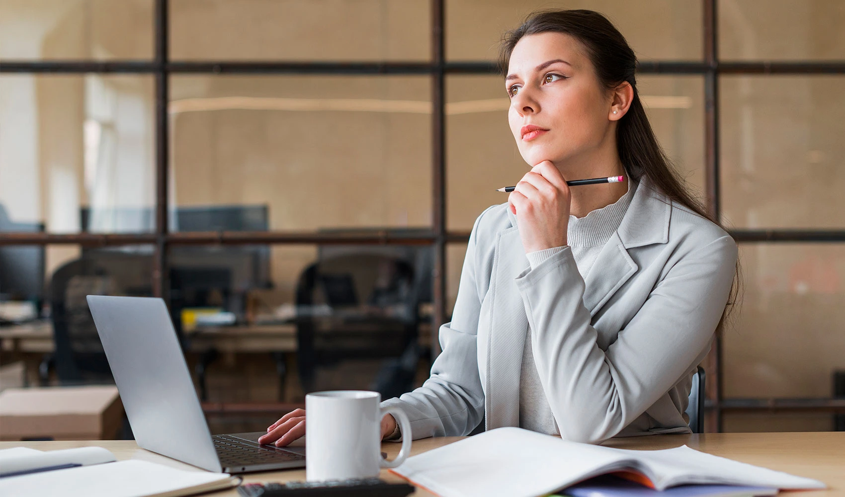 Businesswoman sitting in-front of a laptop at the office