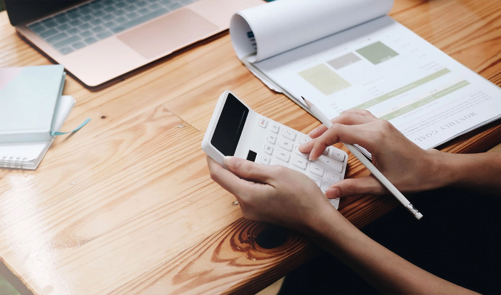 Business woman using calculator