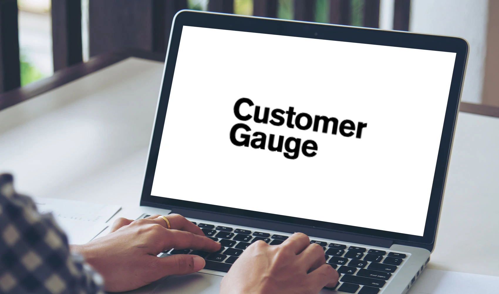Laptop screen with CustomerGauge logo