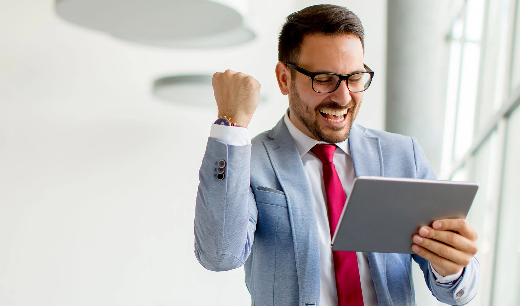 Happy businessman with digital tablet