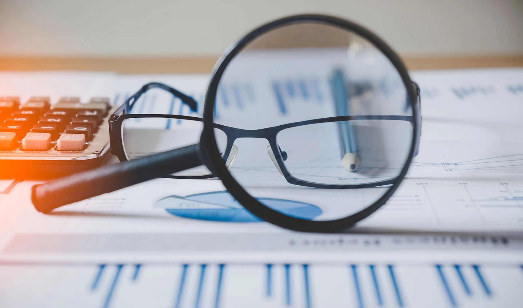 Charts graphs with magnifying glass