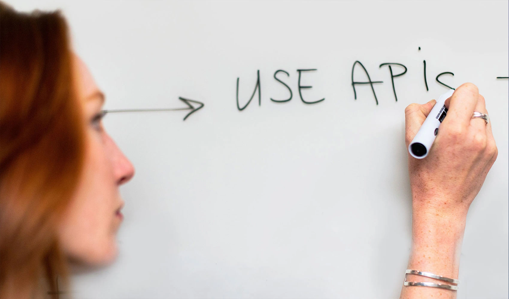 Woman writing on whiteboard