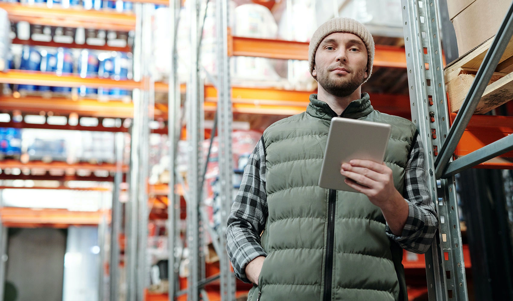 Man in bubble jacket holding tablet device
