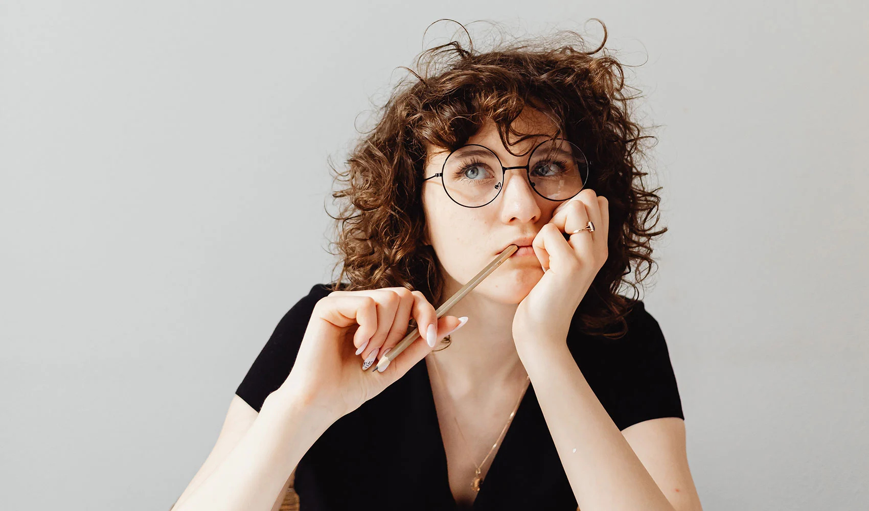 Woman in black V-neck shirt wearing eyeglasses