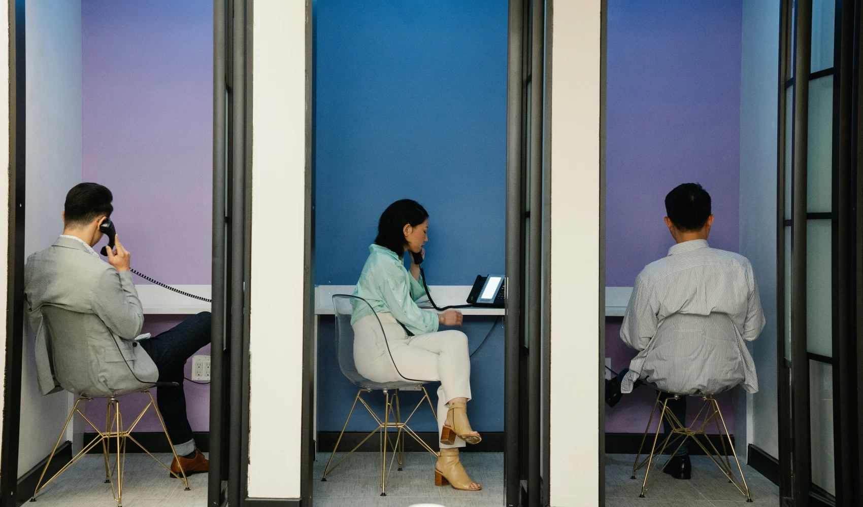 Three people working in cubes