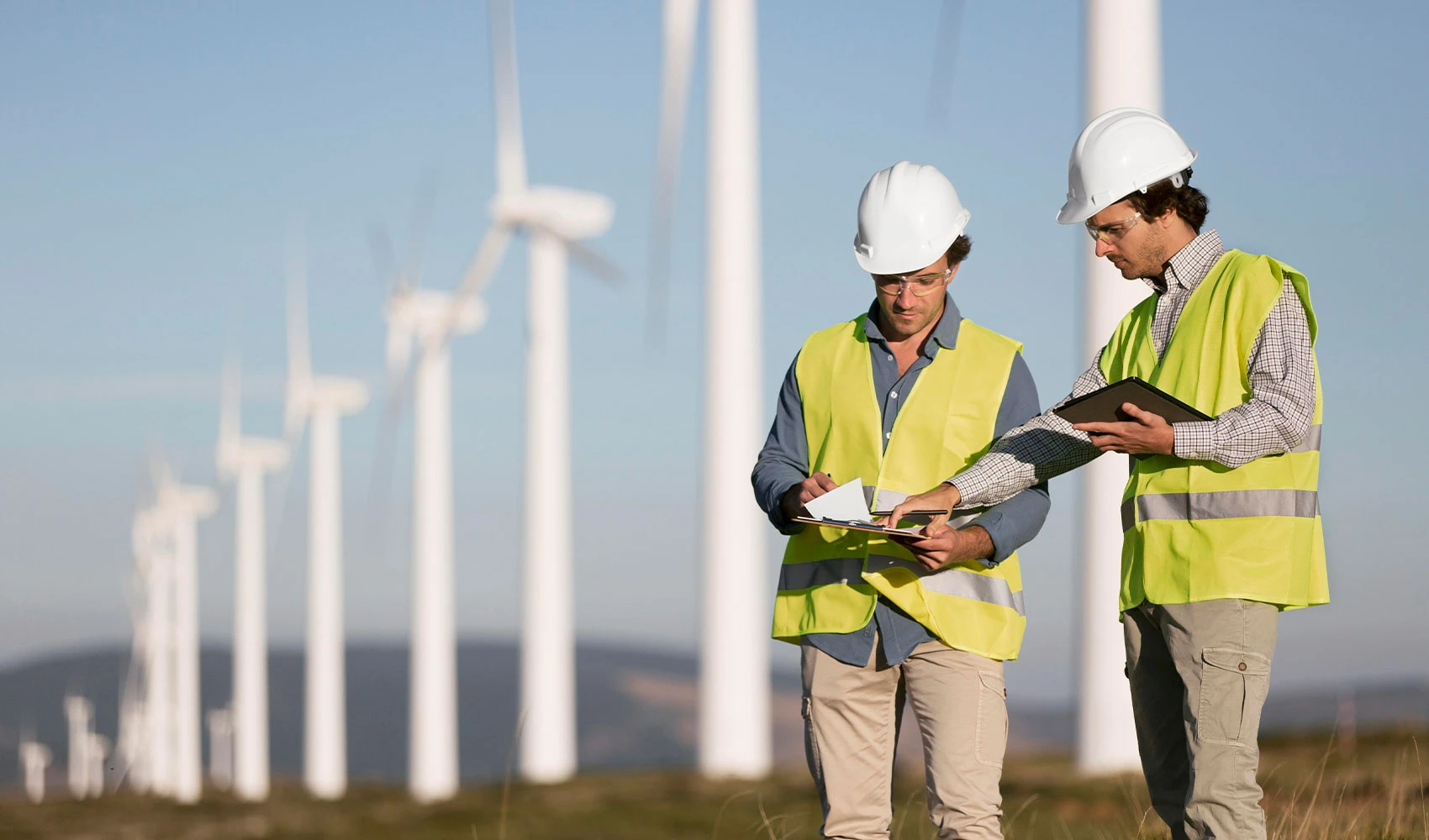 Two workers at the wind farm fields