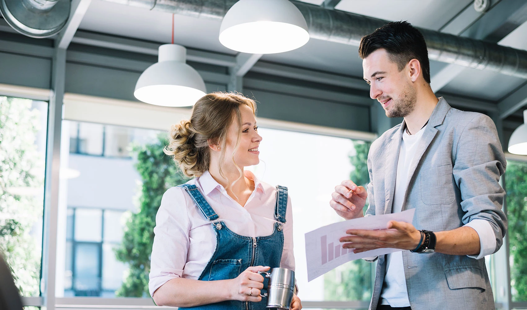 Colleagues cheerfully discussing chart