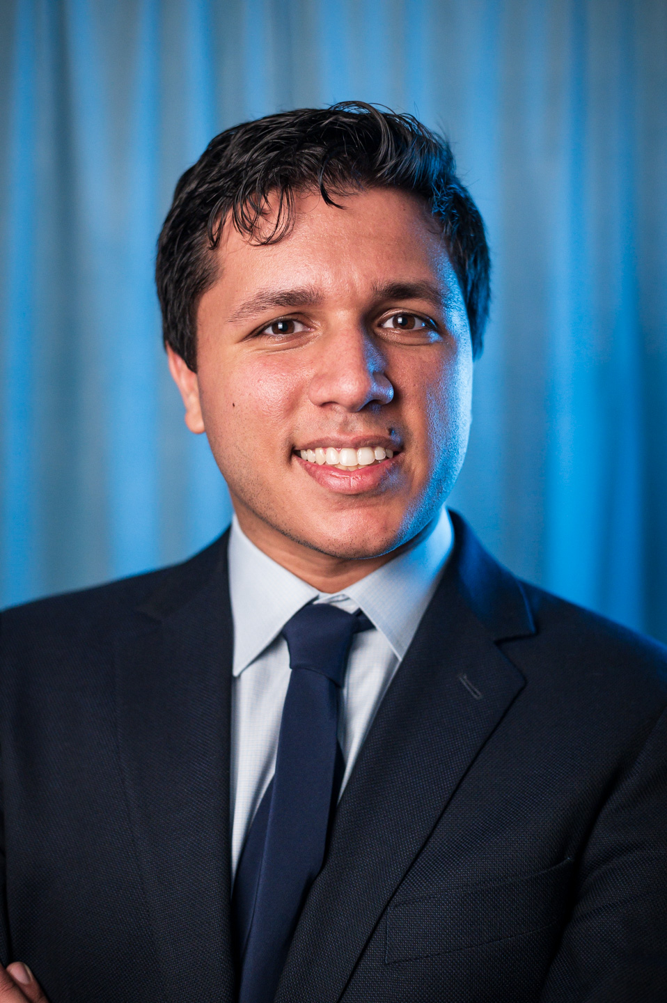 headshot of a young local professional in a stylish suit