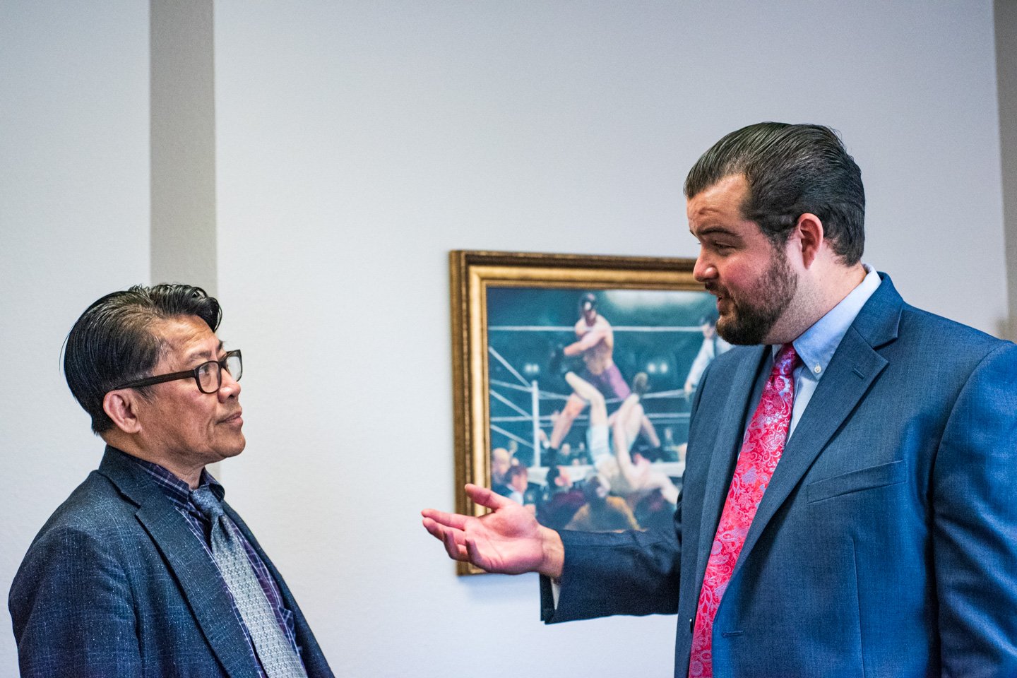 two lawyers speaking inside a corporate office