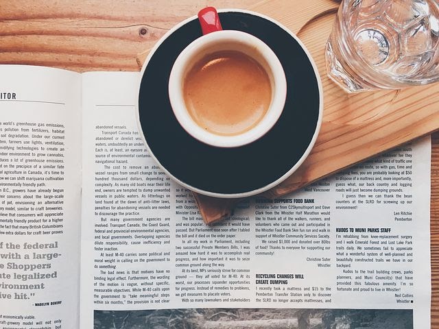 a newspaper and a hot coffee