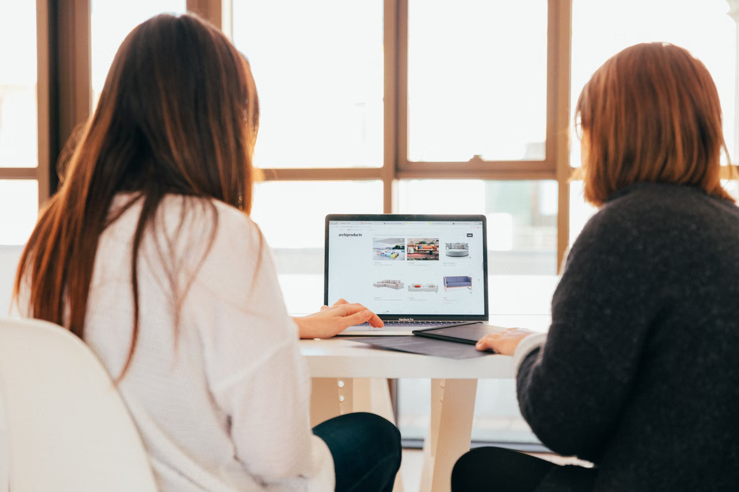 Two women working with a computer