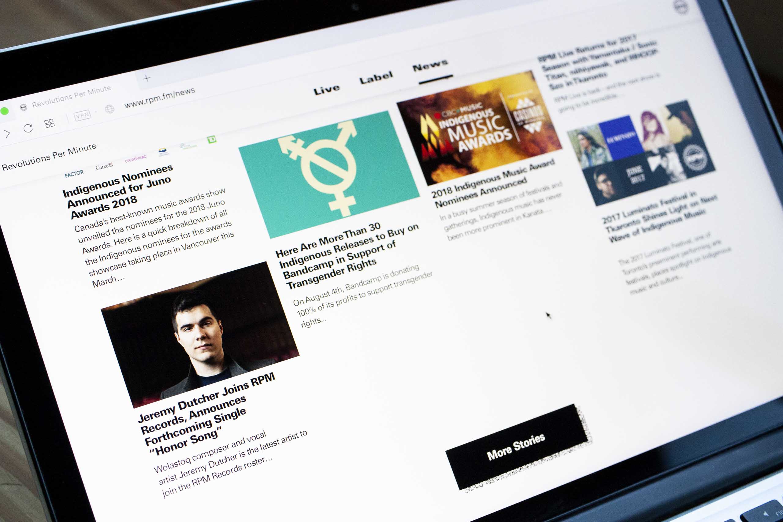 Close of news page showing a four column masonry style grid showing new article feed — by Yagnyuk.