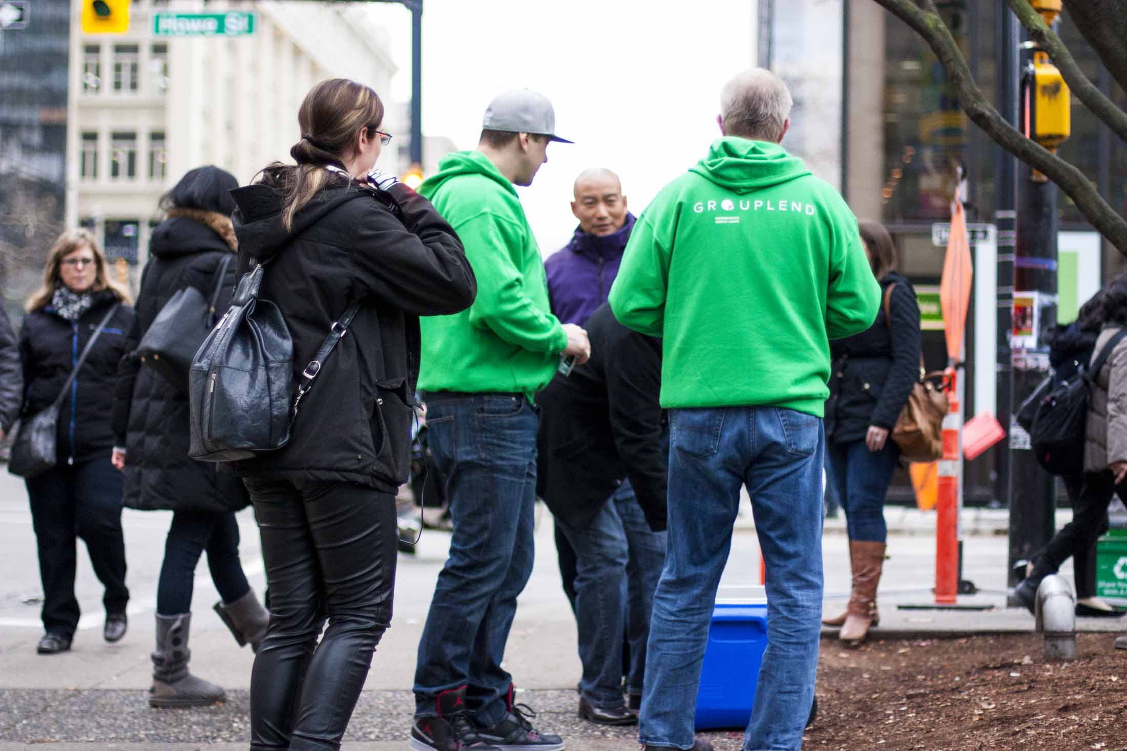 Grouplend team members in neon green branded sweaters at the Vancouver Art Gallery encouraging passerby to participate — by Dima Yagnyuk.