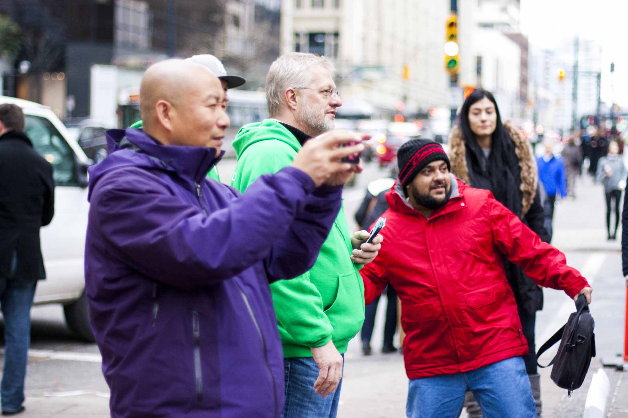 A man in bright red jacket throwing a ballon at the Credit Card costumed Grouplend CEO Kevin Sandhu — by Yagnyuk.