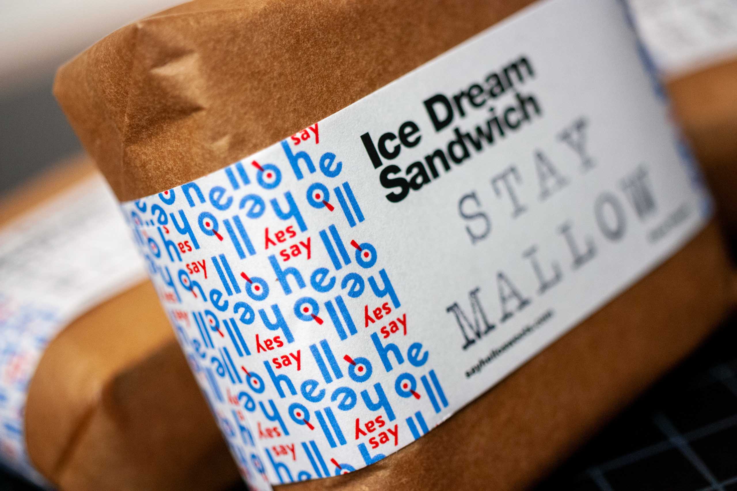 Macro shot showing repeating "Say Hello" brand pattern used for ice cream sandwich wrappers — by Dima.