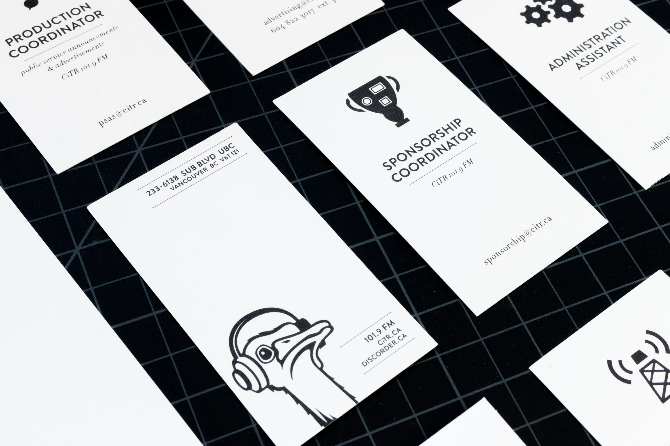 Close up of Sponsorship coordinator business cards for CiTR Radio featuring an illustration of a trophy with badges on it — by Yagnyuk.