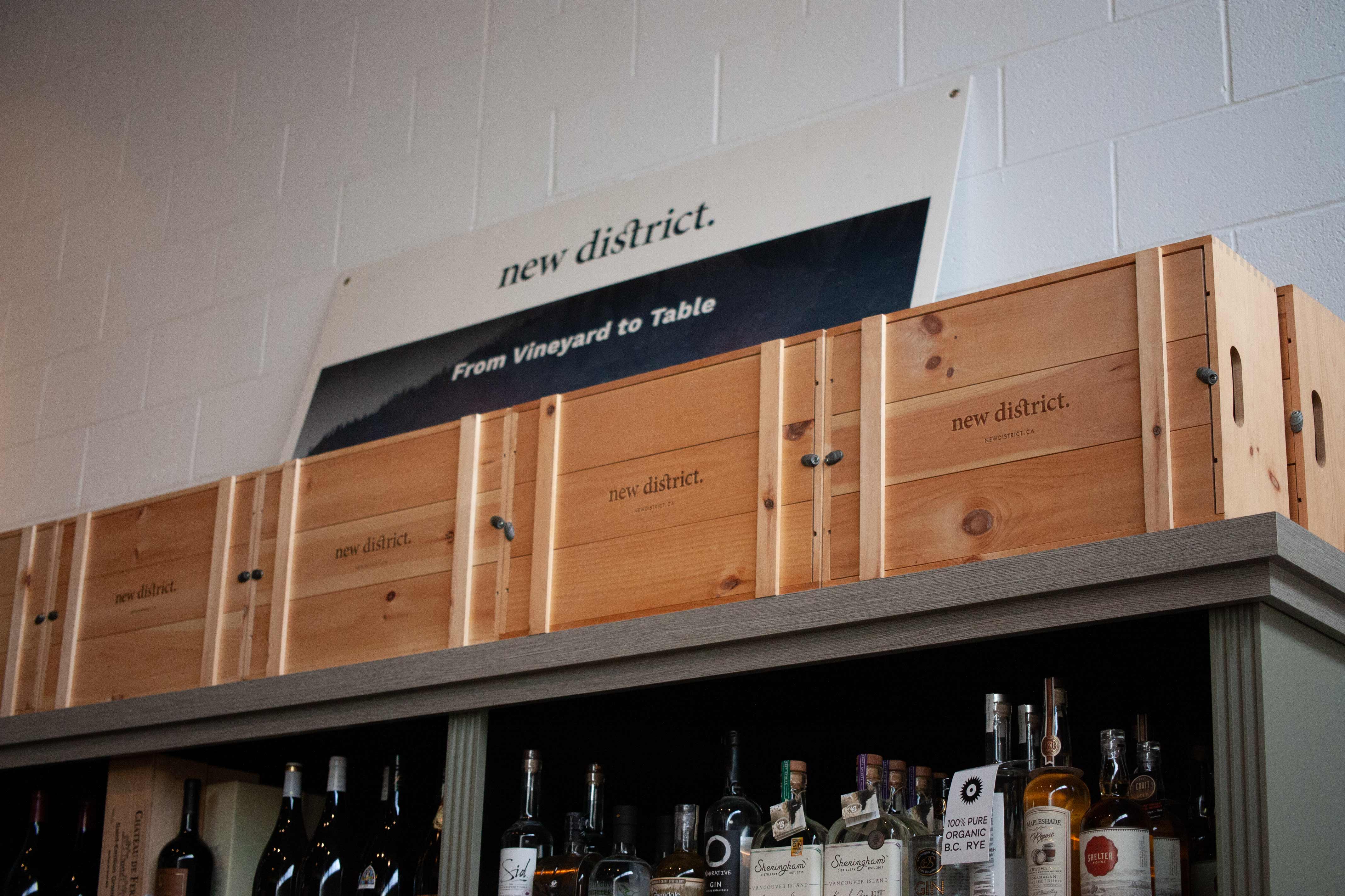 New Districts store shelving with wooded gift packaging on top — Environmental by Dima Yagnyuk.