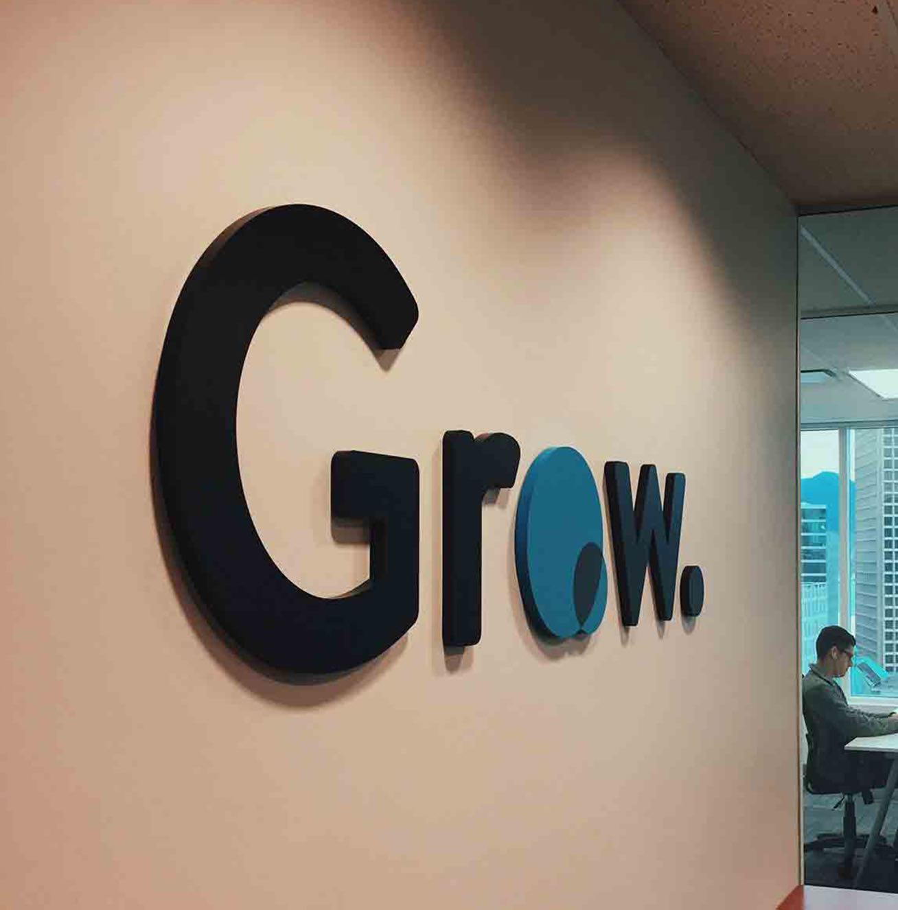 Grow Financial Technologies logo installed on an office wall.