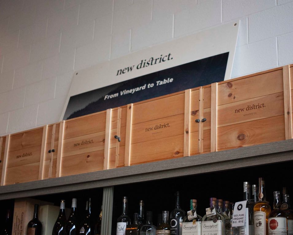 New Districts interior shelving with custom wooden packaging stacked on top — by Yagnyuk.
