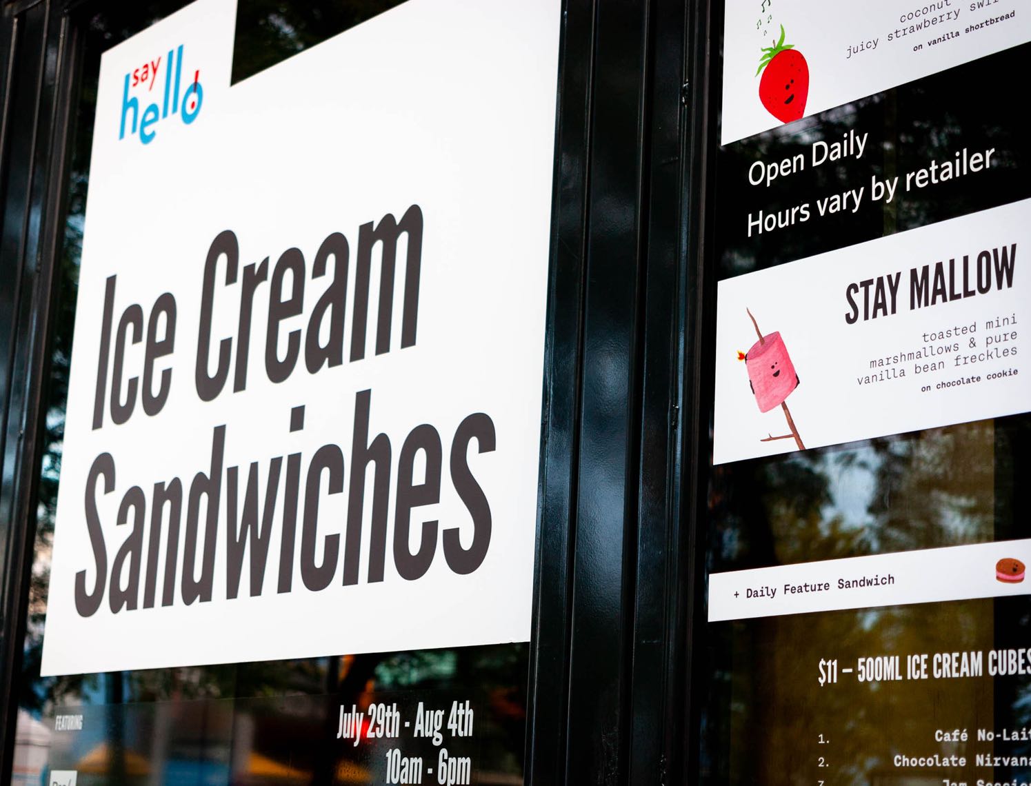 Close up of Say Hello Sweets Store windows advertising ice cream sandwiches — by Dima.