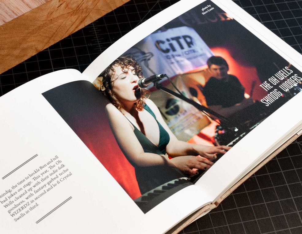 Annual Report for CiTR radio featuring a photo of Sarah Jickling the lead singer of 'The Oh Wells' playing at the Shindig competition — by Yagnyuk.