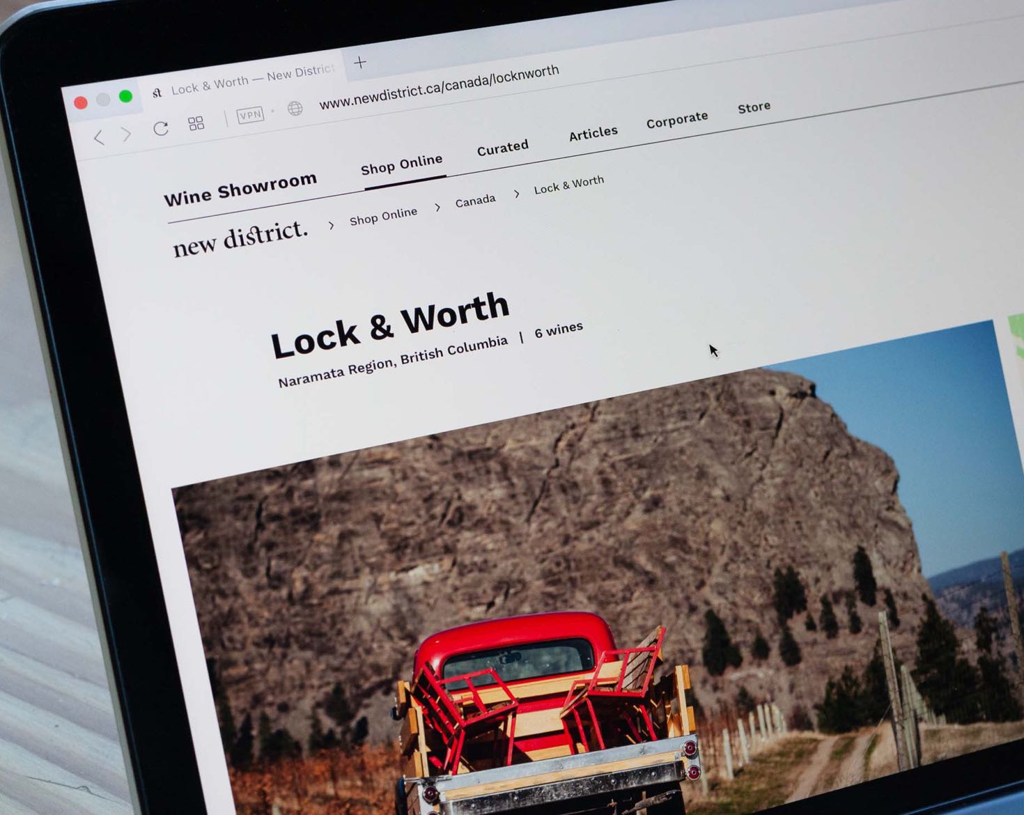 New District E-Commerce winery page for Lock&Worth with large photo of a red truck against a mountain backdrop — by Yagnyuk.