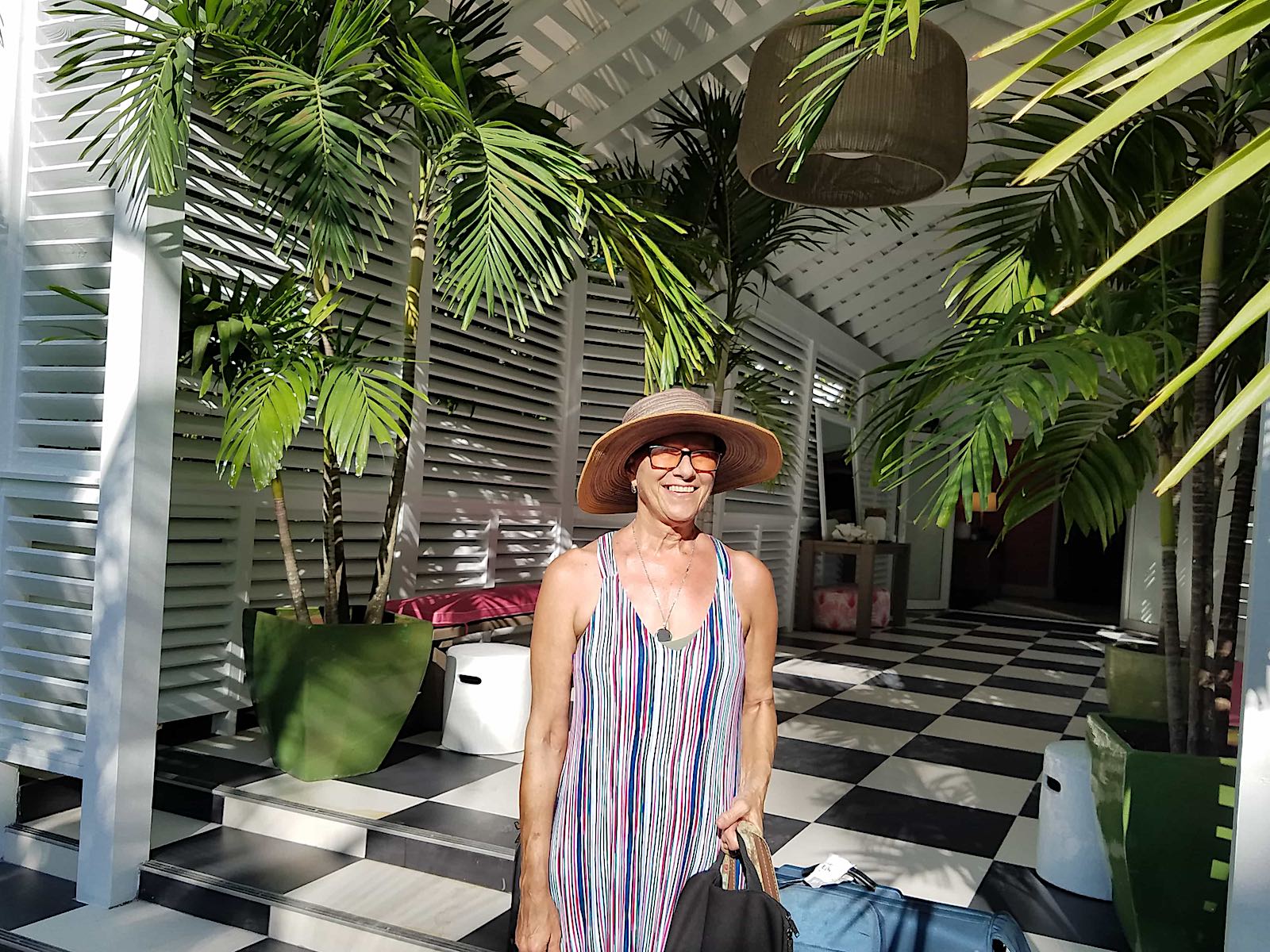 gail in the lobby of a tropical resort