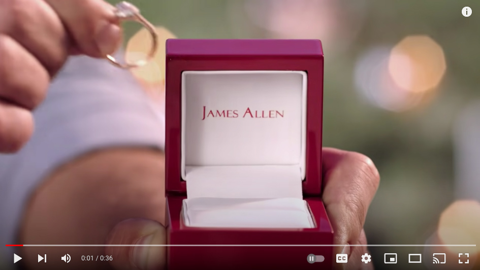 Screenshot of James Allen's video ad, with its product and logo in the center