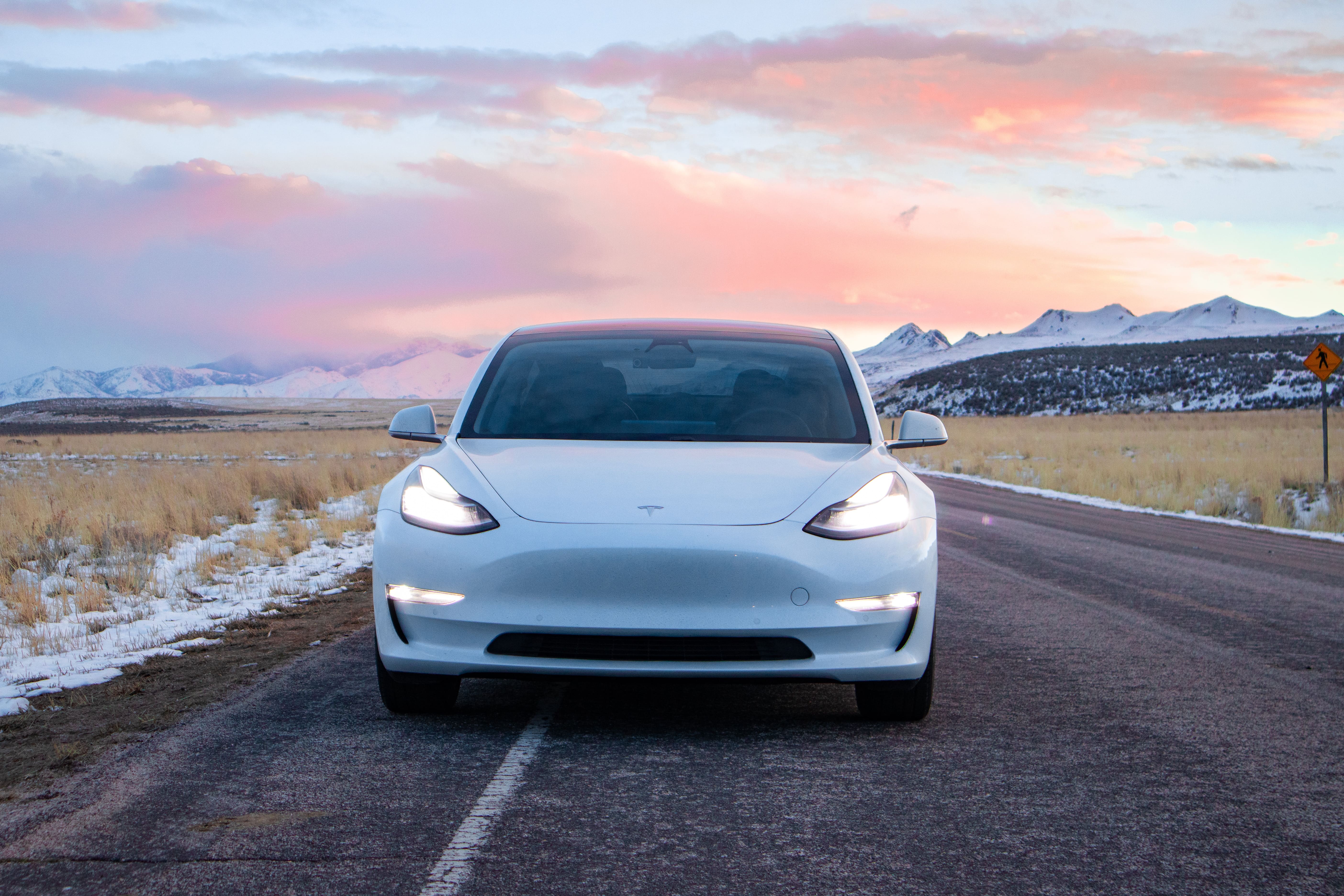white Tesla Model 3 on a highway road