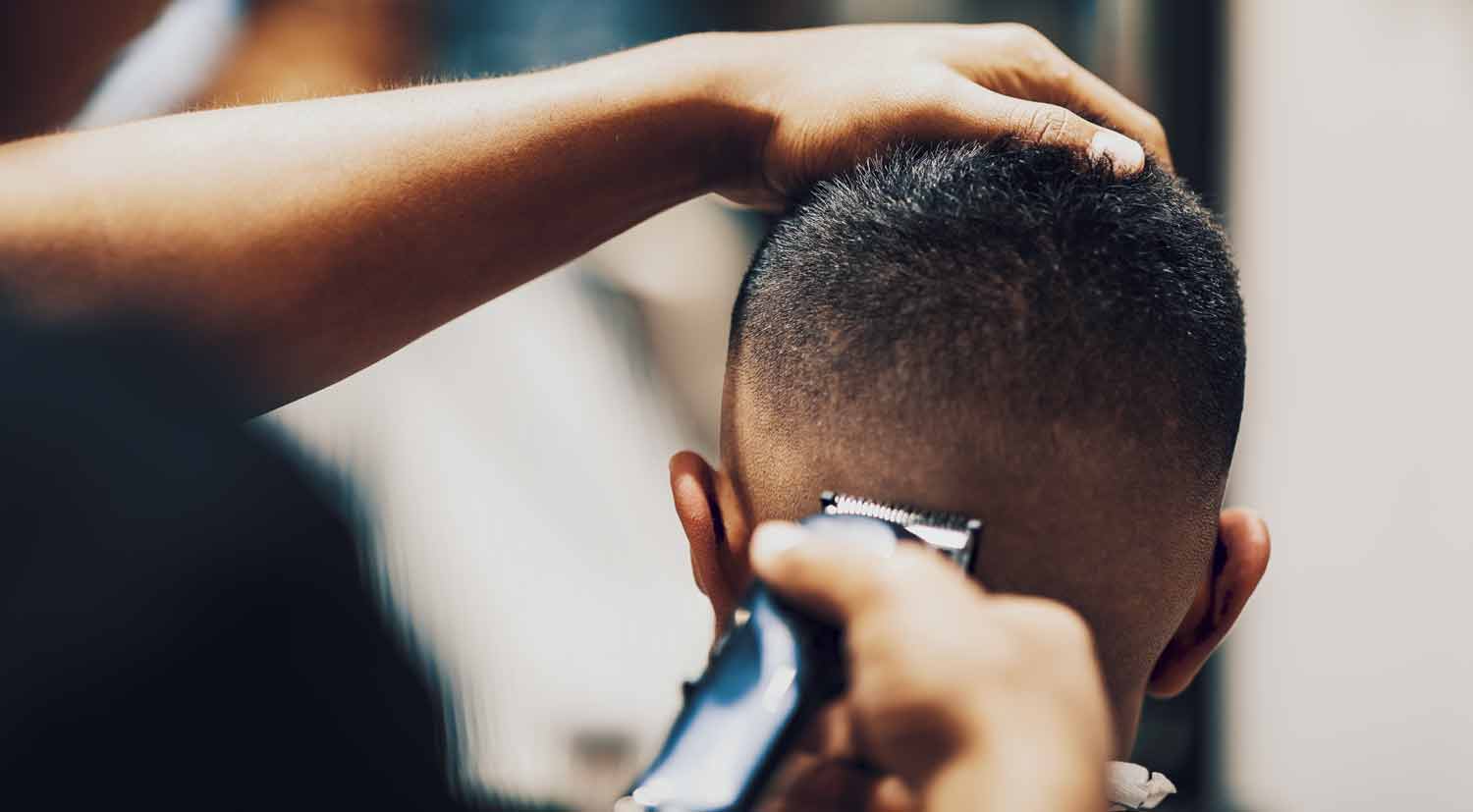 Apprentice Barber Performing A High Fade Hairstyle