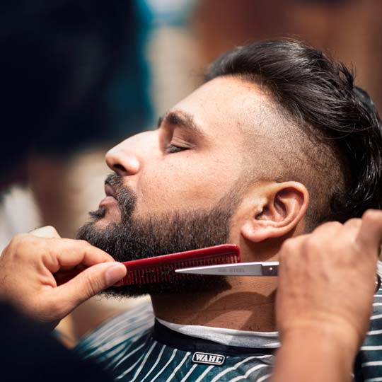 Barber Trimming Beard