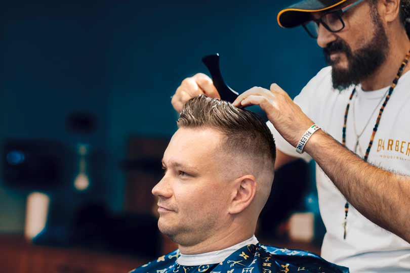 Barber combing hair