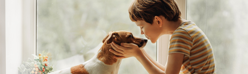 Child and dog snuggling