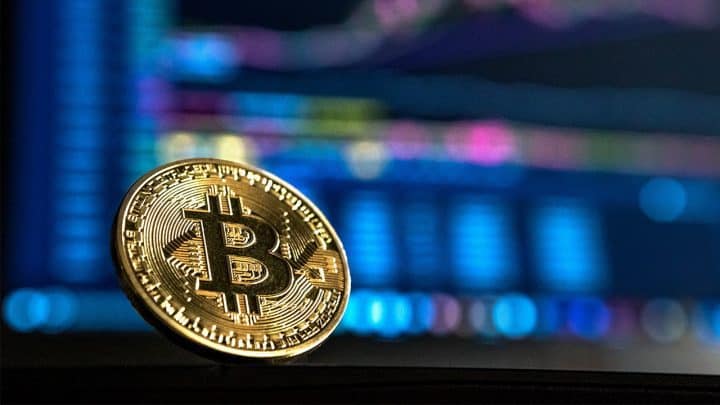 bitcoin infront of a computer