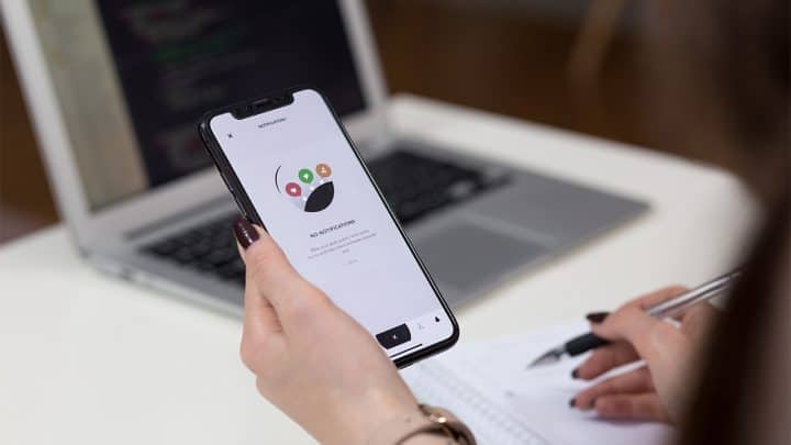 a woman lift a phone with mobile app