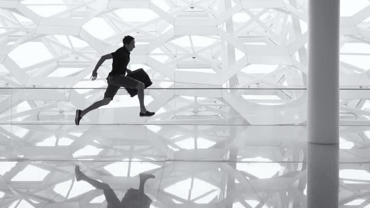 a man running with a baggage at an airport
