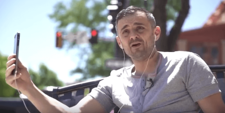 Gary Vee using his phone and earphones
