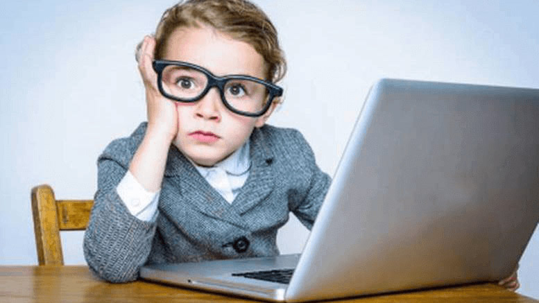 A kid with oversized glasses and laptop