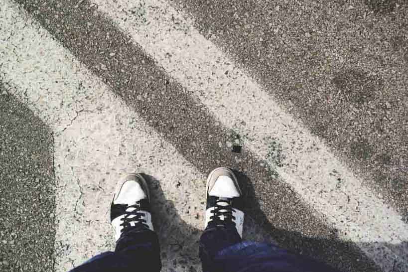 A man's shoes on the pavement