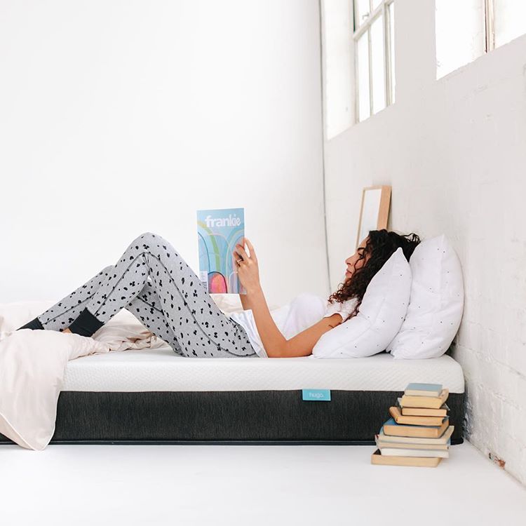 Woman reading a magazine on the Hugo mattress