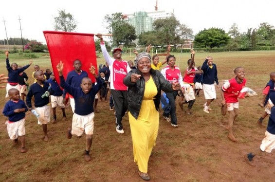 Staff encouraged students on the long, muddy trek from Kwa Watoto School to the Stima Club grounds.