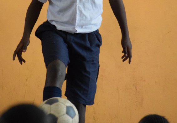 A student skillfully demonstrates the art of soccer dribbling.