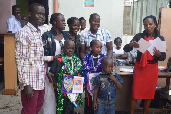 Robert Were, Mawewa School custodian, with twin daughter graduates from PP3.