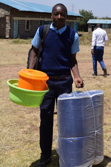 Form 1 student, Teddy, arriving with personal effects in hand.