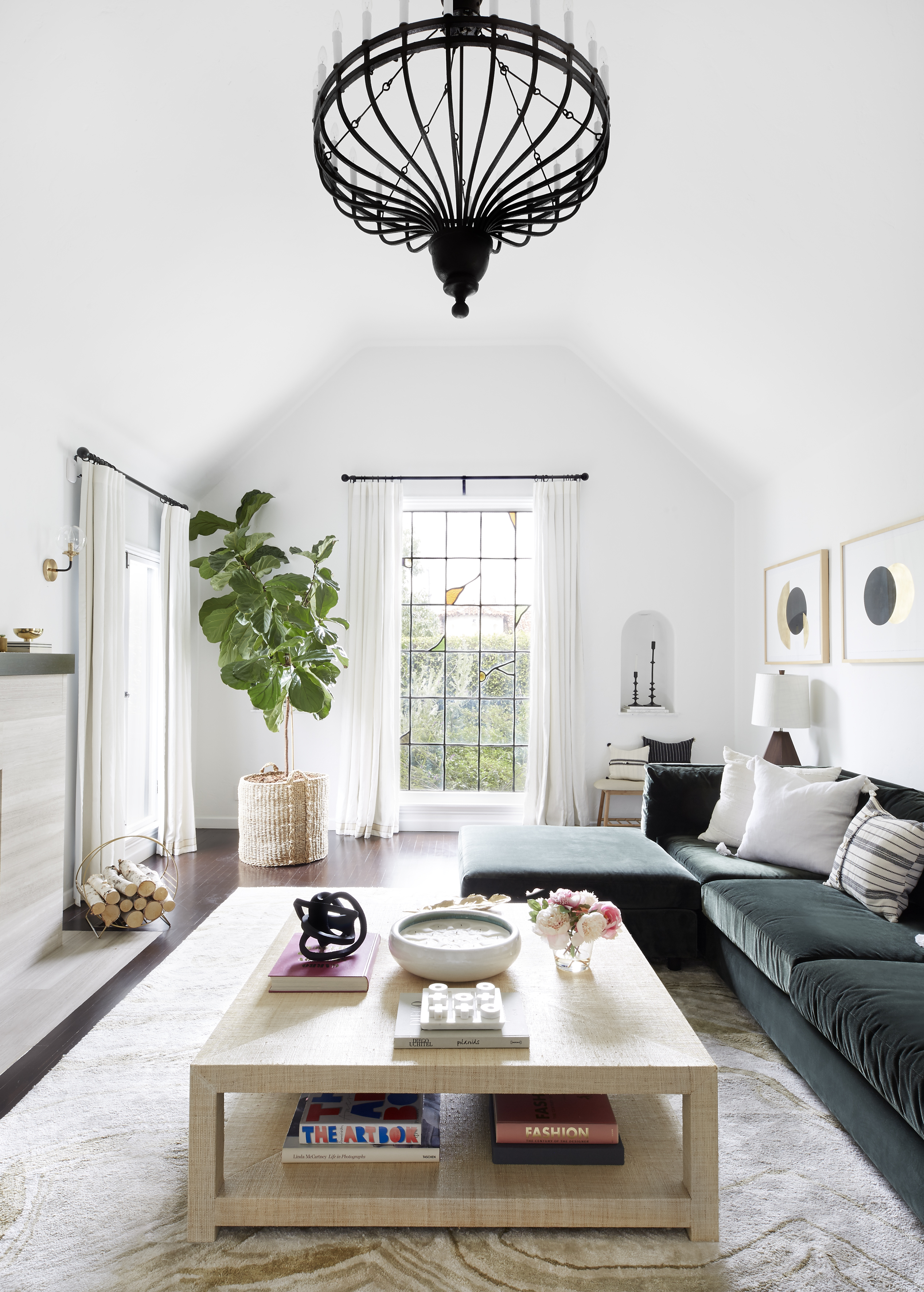 Large window coverings are mounted above the frame to add height and interest in the living room