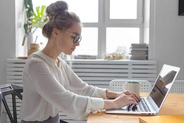 sideways-shot-serious-fashionable-young-european-businesswoman-wearing-stylish-white-blouse-round-eyeglasses-keyboarding-generic-electronic-device-checking-email-writing-business-letter_343059-3050.jpg