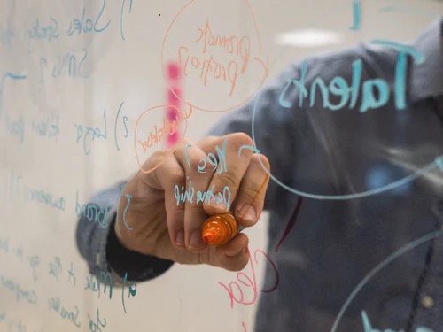Man writing on a whiteboard
