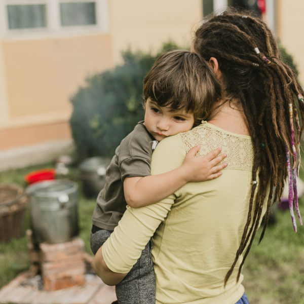 Mother holding unhappy child
