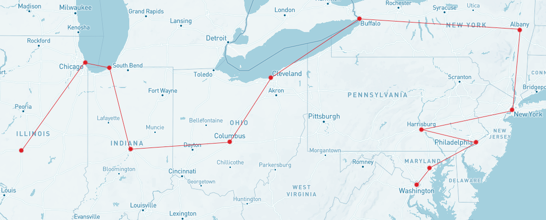 A cropped map of the United States, from Illinois on the left to the Atlantic coast on the right, the bottom half of Michigan at the top, to the top half of Kentucky to the bottom. A red path is outlined to show the path of Lincoln's train journey. Main cities are highlighted: Washington DC, Baltimore, Philadelphia, Hamburg PA, New York NY, Albany NY, Buffalo NY, Cleveland OH, Columbus OH, Indianapolis, Michigan City MI, Chicago, ending in Springfield IL