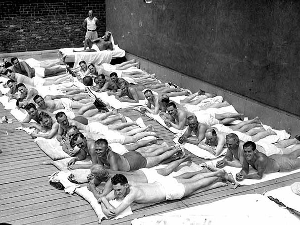 Men sun bathing